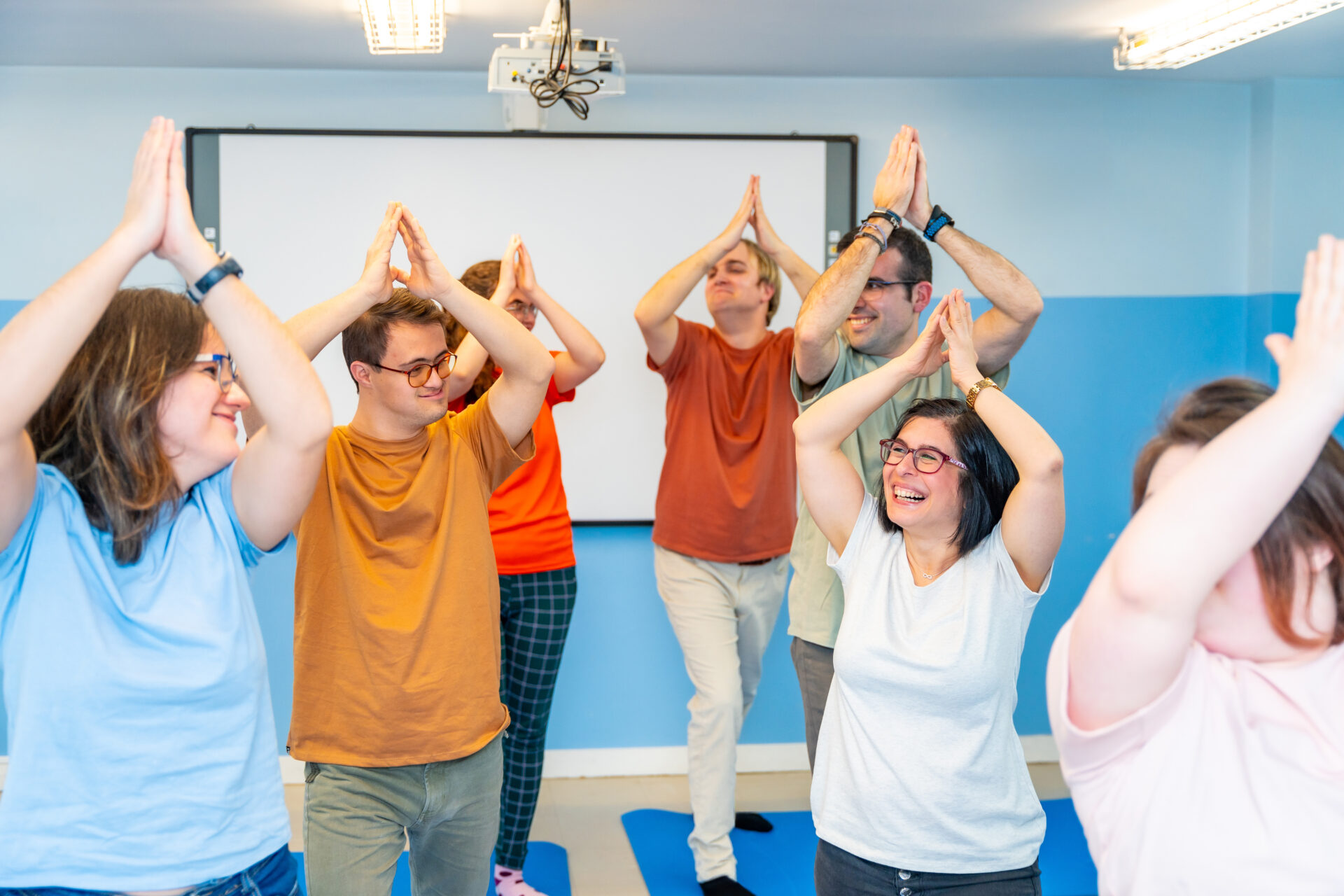 Disabled people having fun during yoga together